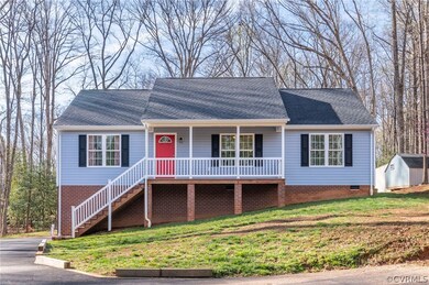 Single story home featuring a storage unit, a fron