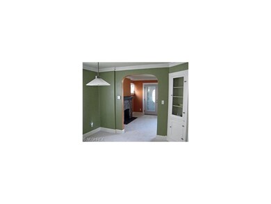 An arched doorway leads to the charming formal din