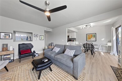 Living area with baseboards, visible vents, light