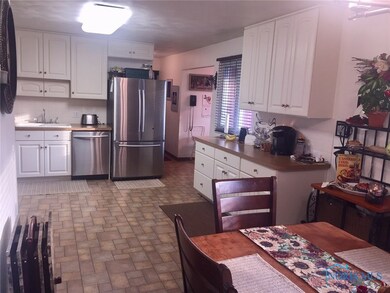 Large stainless steel kitchen fully open to dining