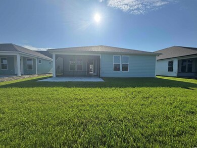 Back of house with a patio and a lawn