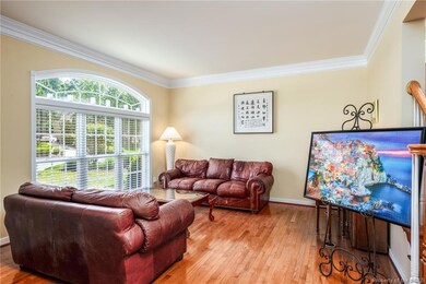 Formal Living Room with hardwood floors and crown molding.