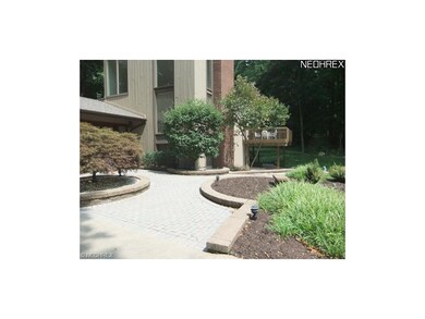 The manicured brick walkway leads to the entrance 