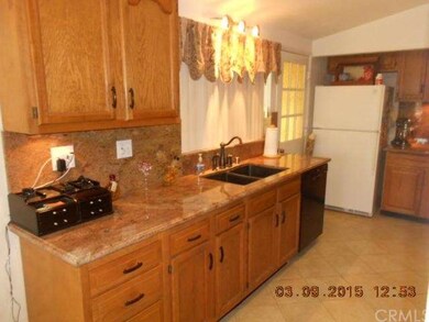 The remodeled kitchen features granite counters an