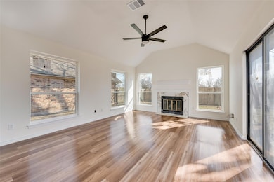 Unfurnished living room featuring vaulted ceiling,