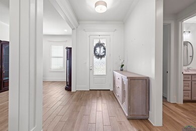 Foyer entrance featuring ornamental molding and light wood-type flooring