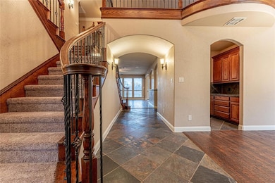 The double staircase is beautiful.  New Carpet on stairs and all of 2nd story.  First floor has slate and wood floors.  Home is gently lived in and waiting for a new family!  Entry leads into a formal dining room on the right and a secondary bedroom,