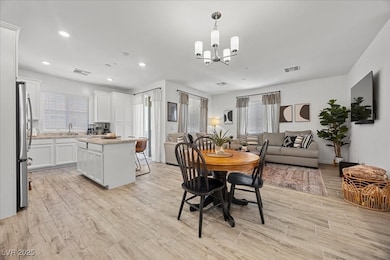Dining area with light wood finished floors, reces