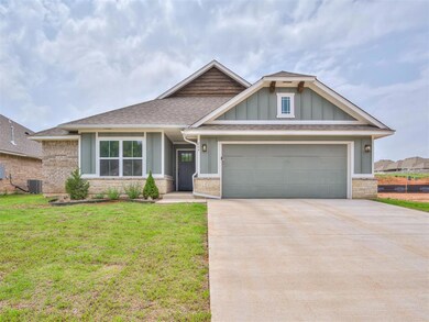 View of front of house with a front yard, a garage