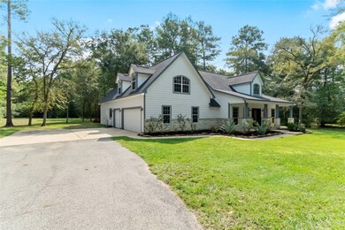 Oversized 3 car garage has tons of cabinet storage space, a storage room, workbench and is long enough for a boat.  There is also an exterior RV plug next to garage.