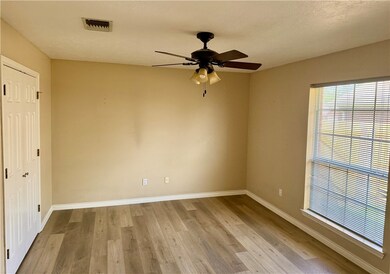Empty room with ceiling fan, wood finished floors,