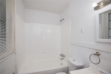 Full bathroom featuring tile walls, bathtub / shower combination, and vanity