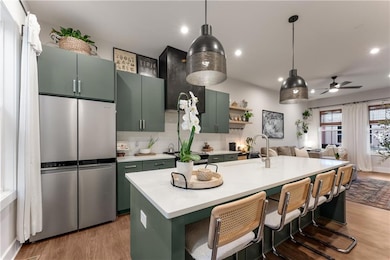 Kitchen featuring light wood finished floors, a ce