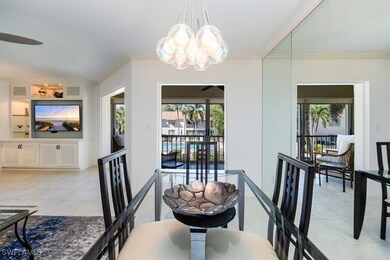 Dining area featuring visible vents, ceiling fan with notable chandelier, crown molding, light tile patterned floors, and lofted ceiling