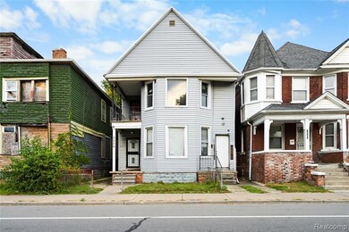Victorian house with a balcony and brick siding