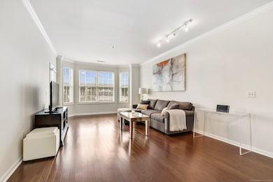 Living room with bay window and access to balcony