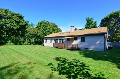 Side view of the home across the expansive yard wi