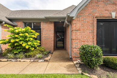 Property entrance with brick siding and roof with shingles