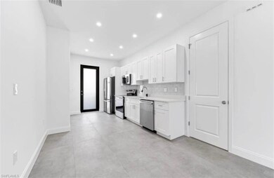 Kitchen with appliances with stainless steel finishes, light countertops, white cabinets, recessed lighting, and decorative backsplash