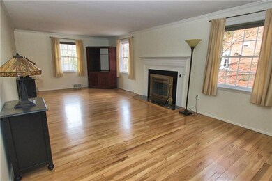 This large neutral living room has a working firep