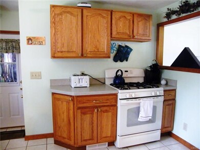 Kitchen - More storage, stove, and peek through to