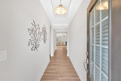 Hallway with baseboards and light wood-type floori