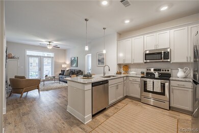 Kitchen featuring light wood-type flooring, stainl