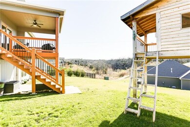 Steps from the deck down to the expanded covered p