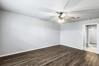 Empty room featuring ceiling fan, hardwood / wood-