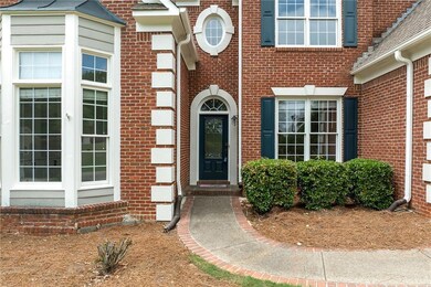 View of exterior entry featuring brick siding