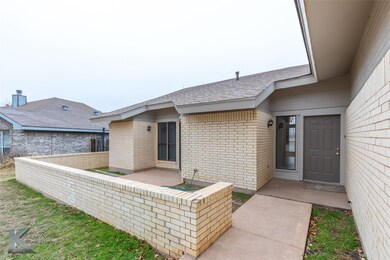 Doorway to property featuring a patio area