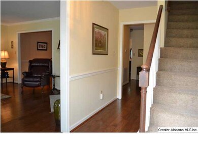 Welcoming entrance foyer with chair rail molding, 