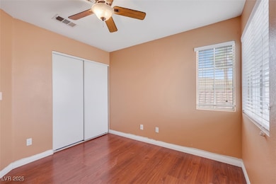 Unfurnished bedroom with wood finished floors, a ceiling fan, and a closet