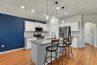 Kitchen with a kitchen island with sink, a sink, 
