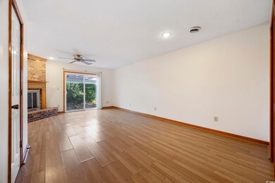 Unfurnished living room with visible vents, a fire