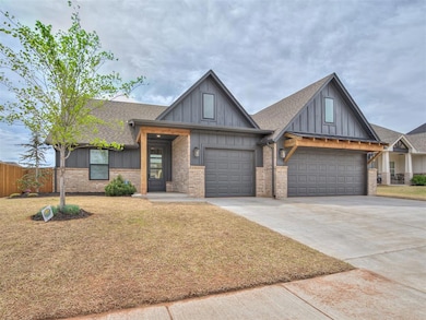 View of front of property with a garage, board and batten siding, a shingled roof, concrete driveway, and brick siding
