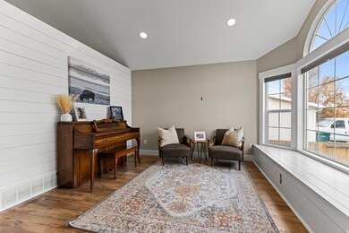 Living area featuring wood walls, dark wood-style floors, recessed lighting, and lofted ceiling