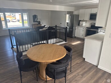 Dining area with dark wood finished floors and baseboards