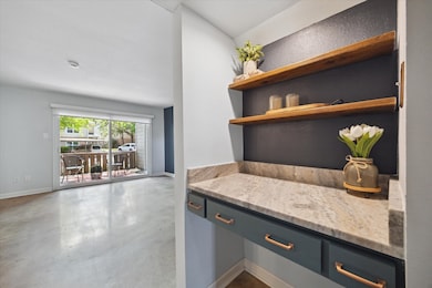 A stylish nook with open wooden shelves and a gran