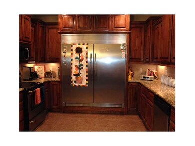 Kitchen. Custom built in double door stainless steel fridge