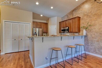 Kitchen featuring kitchen peninsula, a breakfast b