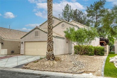 View of front of property with stucco siding, a ga