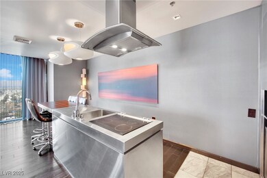 Kitchen featuring black electric stovetop, stainle
