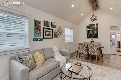 Living room featuring vaulted ceiling with beams, 