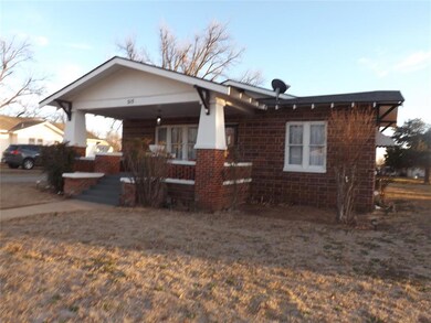 View of front of house with covered porch and bric