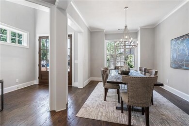 Dining room featuring crown molding, dark hardwood