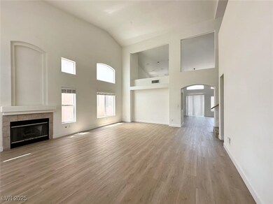 Unfurnished living room with high vaulted ceiling,