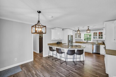 Kitchen featuring white cabinets, appliances with 
