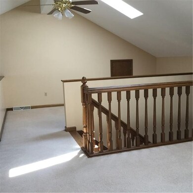 Beautiful oak staircase leading to the loft area.