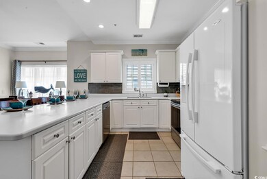 Kitchen featuring visible vents, a peninsula, appl
